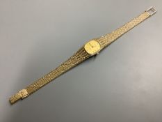 A lady's modern 9ct gold Tissot Saphir quartz wrist watch, on integral 9ct gold bracelet, overall