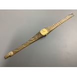 A lady's modern 9ct gold Tissot Saphir quartz wrist watch, on integral 9ct gold bracelet, overall