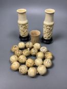 A Chinese engraved bone bead necklace, a pair of engraved bone vases on stands and an engraved