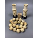 A Chinese engraved bone bead necklace, a pair of engraved bone vases on stands and an engraved