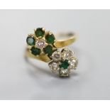 An 18ct, emerald and diamond double flowerhead cluster ring, size M, gross 4.5 grams.