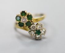 An 18ct, emerald and diamond double flowerhead cluster ring, size M, gross 4.5 grams.