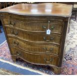 An early 20th century George III style mahogany serpentine chest of drawers with brushing slide,