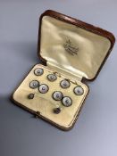 An Edwardian 18ct. gold and platinum, black enamel and pearl, eight piece cuff links, stud and