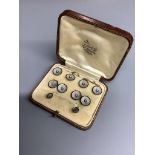 An Edwardian 18ct. gold and platinum, black enamel and pearl, eight piece cuff links, stud and