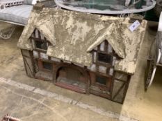 A reconstituted stone garden ornament, modelled as a Tudor cottage, width 86cm, depth 50cm, height