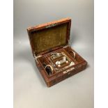 A small leather jewellery box containing assorted silver and other jewellery.