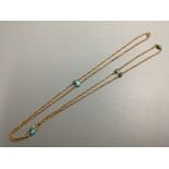 A 9ct and seven stone cabochon turquoise set long chain,102cm, gross weight 16.7 g.