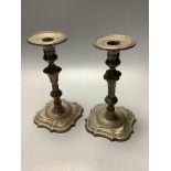 A pair of 18th century continental silver candlesticks, a.f.with waisted knopped stems, on shaped