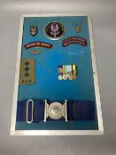 A group of Special Air Service SAS embroidered insignia, a belt and other military items, includes a