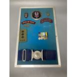 A group of Special Air Service SAS embroidered insignia, a belt and other military items, includes a