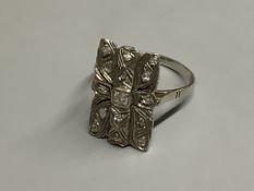 A mid 20th century 18ct white metal and diamond cluster set tablet ring,size Q, gross 4 grams.