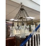 A brass five-light chandelier with etched glass pendant shades