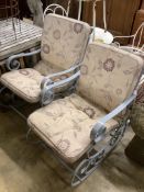 A pair of painted wrought iron garden rocking armchairs with cushion seats, width 57cm, depth