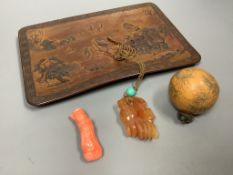 A Chinese carved hardstone pendant, a carved coral Guanyin, an engraved nut pendant, and a lacquered