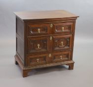 A William & Mary oak chest,with moulded rectangular top over three geometric moulded panelled