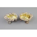 A pair of George IV silver shell shaped salts, by Paul Storr,with engraved crest and gilt interior,
