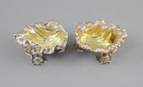 A pair of George IV silver shell shaped salts, by Paul Storr,with engraved crest and gilt interior,