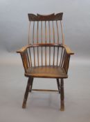 A primitive comb back Windsor armchair, possibly West Country,with a shaped rail above a notch-cut