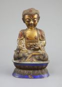 A Chinese copper alloy and enamel seated figure of Buddha Shakyamuni, Qing dynasty,on a double