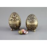 A graduated pair of Edwardian novelty silver gilt condiments, modelled as eggs, with bird's nest