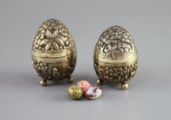 A graduated pair of Edwardian novelty silver gilt condiments, modelled as eggs, with bird's nest