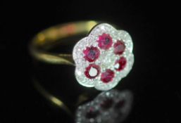 A modern 18ct gold, ruby and diamond set flower head cluster ring,size M, gross weight 3.6 grams.