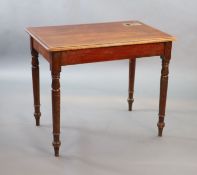 A Victorian mahogany writing table,with rounded rectangular top and brass inset inkwell, on turned