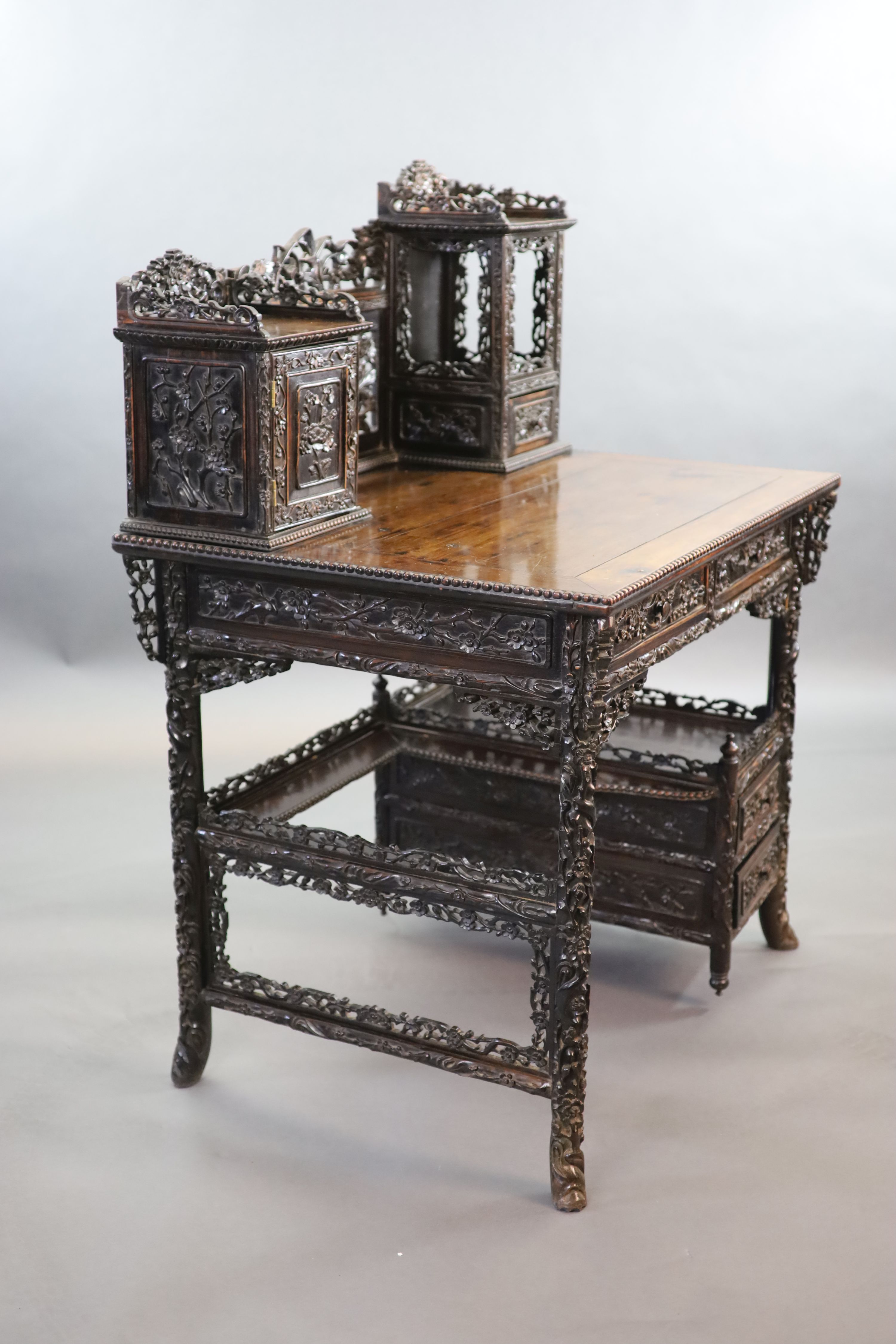 A late 19th century Chinese hongmu desk,carved and pierced throughout with flowers, the raised - Image 4 of 4