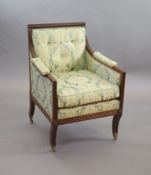 A Regency mahogany library armchair,with reeded frame, upholstered back, arms and seat, on sabre
