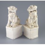 A pair of Chinese Dehua blanc de chine Buddhist lion joss stick holders, Kangxi period,each