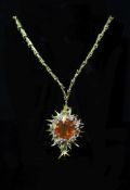 A stylish 1970's George Weil 18ct gold, platinum, fire opal and diamond set shaped oval pendant