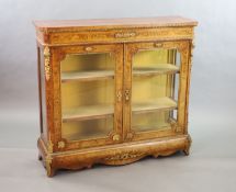 A Victorian ormolu mounted marquetry inlaid walnut bookcase,with D shaped top and two glazed doors