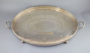 An Edwardian silver two handled oval tea tray, by Walker & Hall,with pierced gallery, on ball feet,