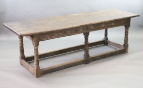 A 17th century oak and elm refectory table,with rectangular top, foliate carved frieze and cannon