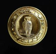 A Victorian gold target broochcentred with an owl perched upon a branch, 3.8cm, 15.8 grams.