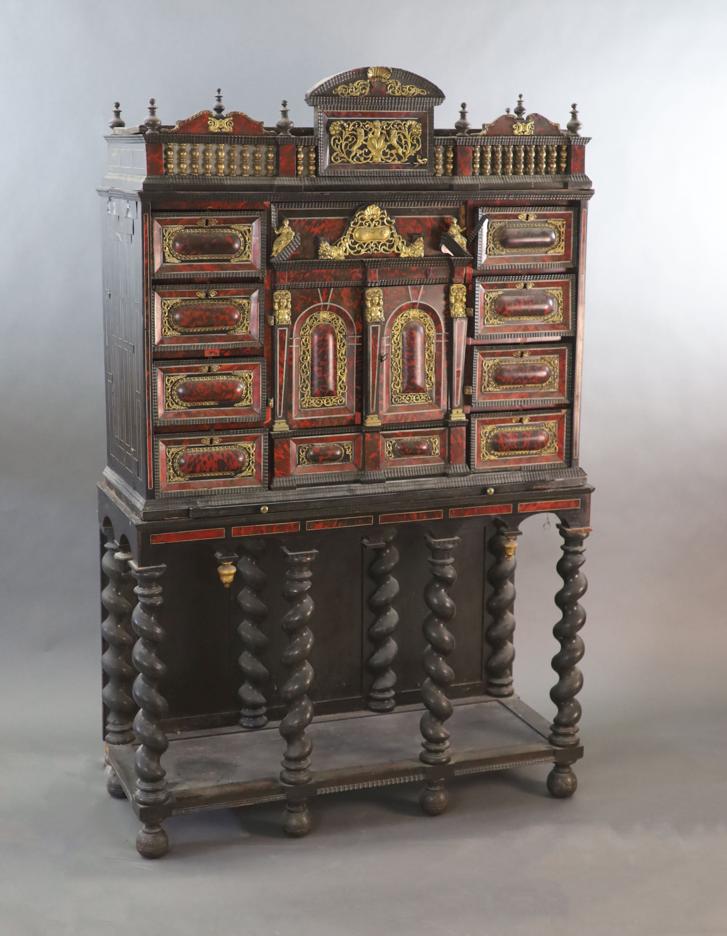 A late 17th century Portuguese ormolu mounted ebony and red tortoiseshell cabinet on stand,of