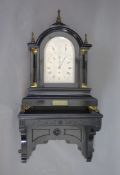 A large late Victorian ebonised bracket clock with bracketthe arched silvered dial with Roman