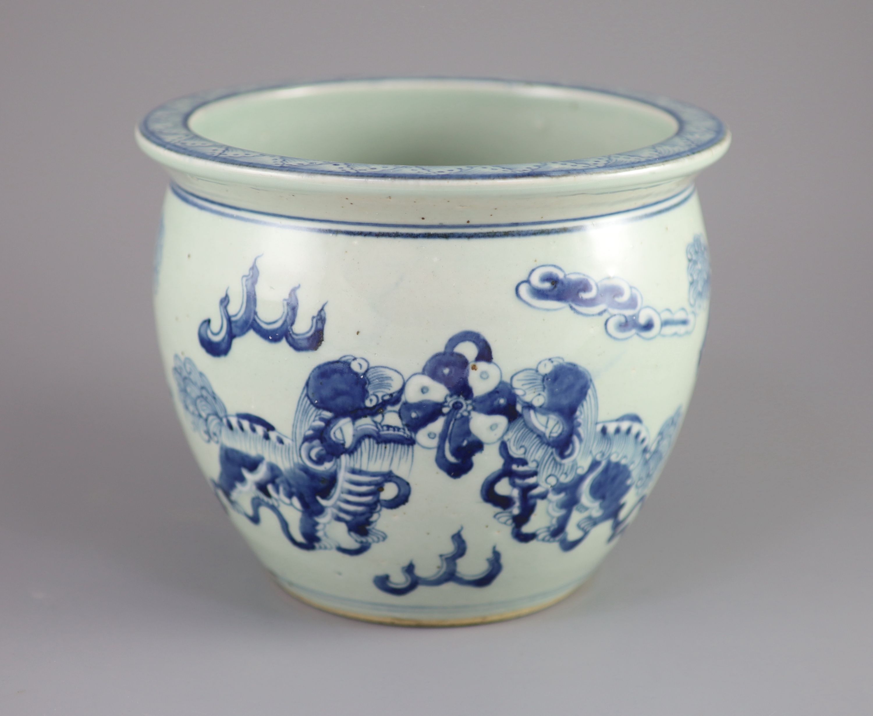 A Chinese blue and white 'lion-dog' flower pot,painted with lion-dogs on white slip, on a pale