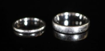 A lady's and gentleman's Tiffany & Co platinum wedding band set,the lady's size K/L and signed and
