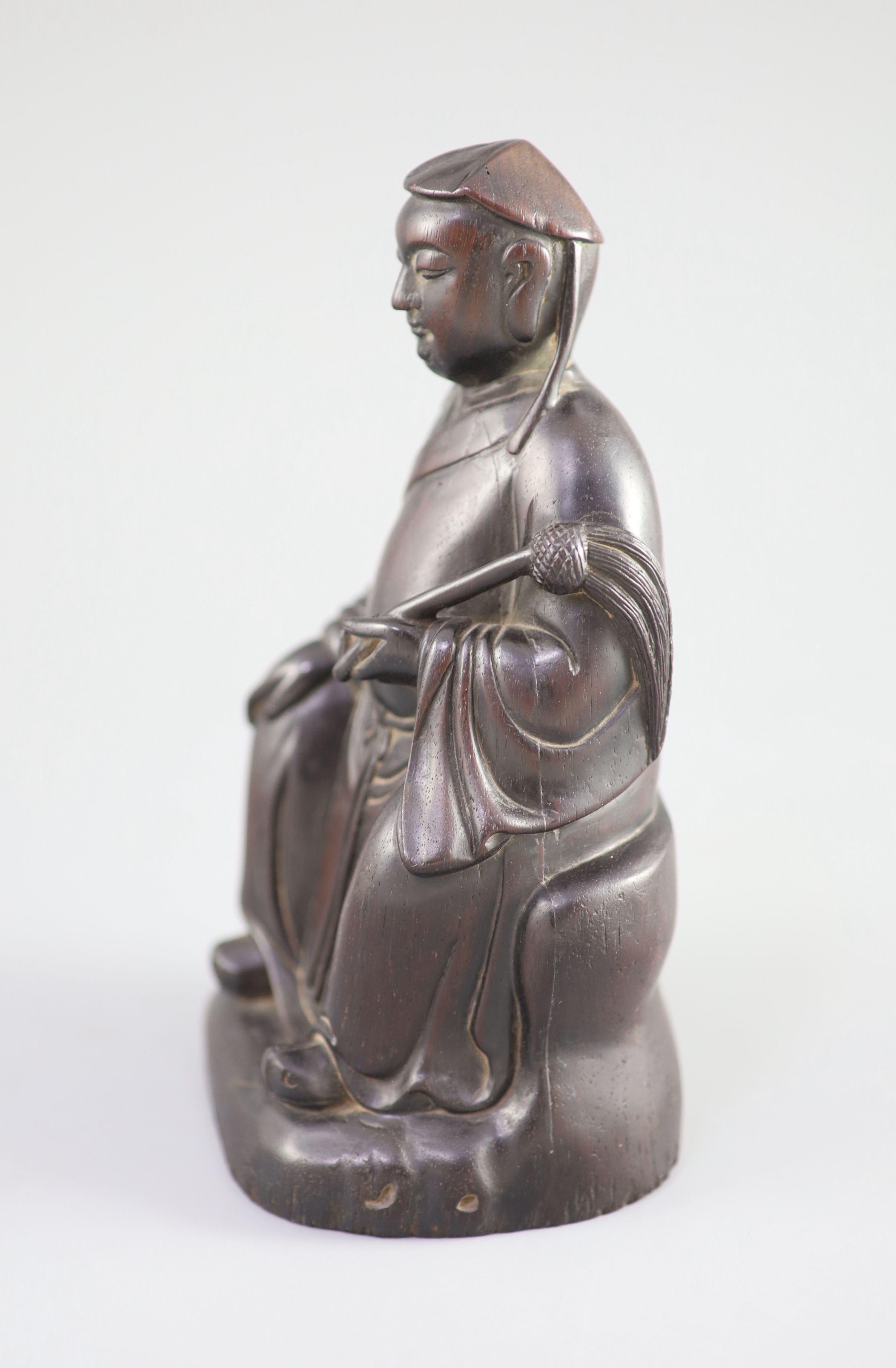 A Chinese Zitan seated figure of an official, 18th century,the figure holding a fly whisk in his - Image 3 of 5