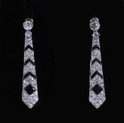 A pair of Cartier Art Deco French platinum, black onyx and diamond set tapering drop earrings,set