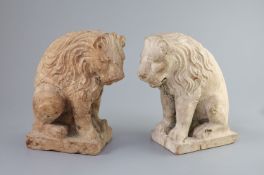 A pair of European pink marble seated lions, 18th century or earlier,the marble possibly rose