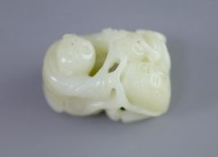 A Chinese pale celadon jade group of a boy and a lion-dog, 19th/20th century,the lion-dog grasping