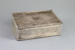 A 1950's engine turned silver rectangular cigarette box, by Mappin & Webb,with foliate borders,