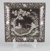 A Chinese lac burgaute square dish, 18th century,decorated with a scholar fishing on a river bank,