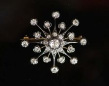 A Victorian, gold, silver and diamond set 'starburst' brooch,the central stone weighing