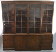 A George III mahogany breakfront library bookcase,with moulded cornice and four astragal glazed