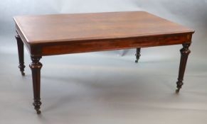 A Victorian mahogany library table,with rounded rectangular top, on turned and fluted tapered legs,