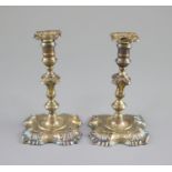 A pair of George II cast silver tapersticks, by Richard Gurney & Co,with knopped stems, on square